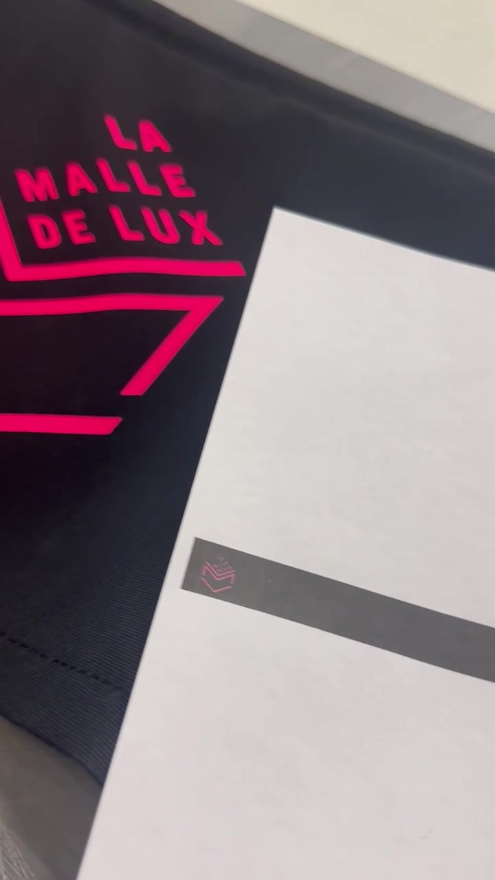 Lambrequin avec logo rose fluo floqué sur toile noire, à côté de son bon à tirer papier